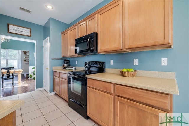 kitchen featuring light tile patterned floors and black appliances