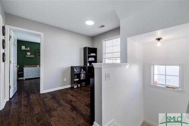 corridor featuring dark hardwood / wood-style floors