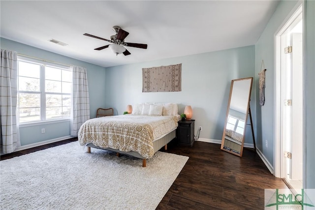 bedroom with ceiling fan and dark hardwood / wood-style flooring