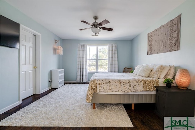 bedroom featuring dark hardwood / wood-style flooring and ceiling fan