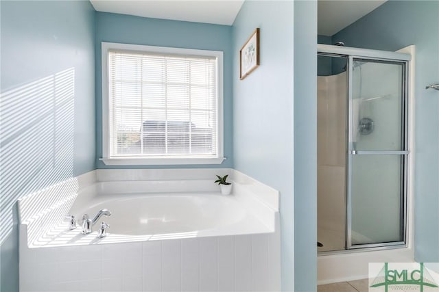 bathroom featuring plenty of natural light and plus walk in shower