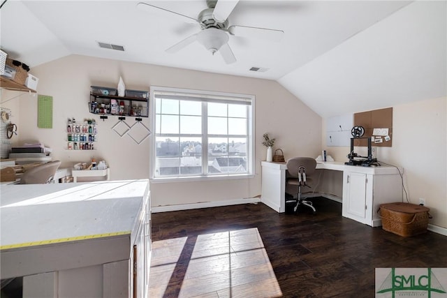 office with ceiling fan, dark hardwood / wood-style flooring, built in desk, and vaulted ceiling