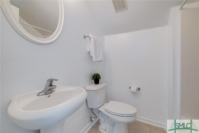 bathroom with tile patterned flooring, toilet, and sink