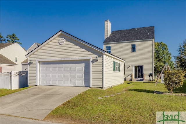 exterior space with a yard and a garage