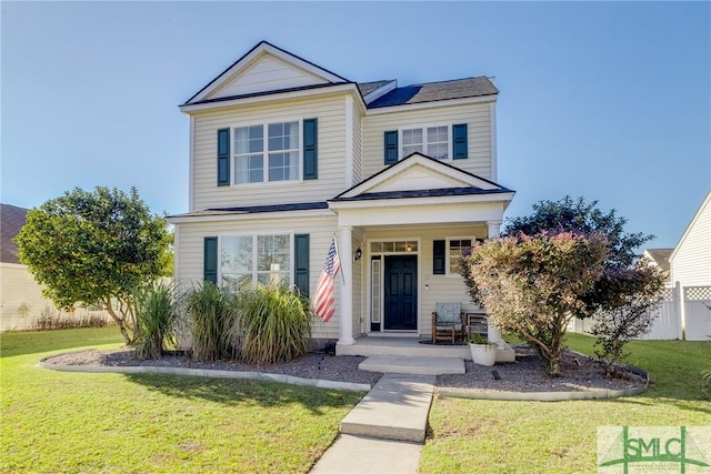 front of property with covered porch and a front lawn