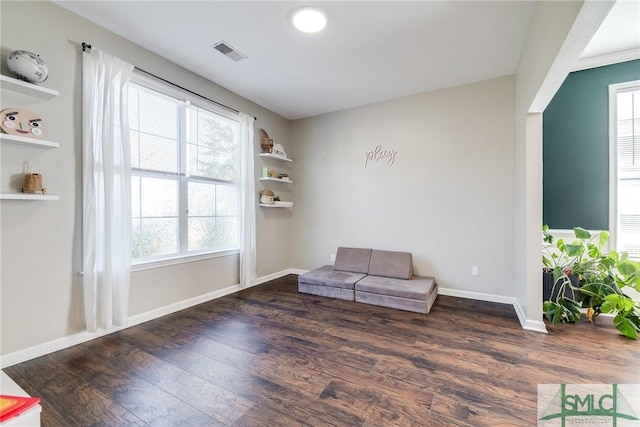 sitting room featuring dark hardwood / wood-style flooring and a wealth of natural light