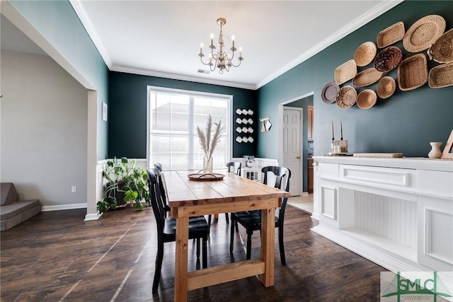 dining space featuring dark hardwood / wood-style floors, ornamental molding, and a chandelier