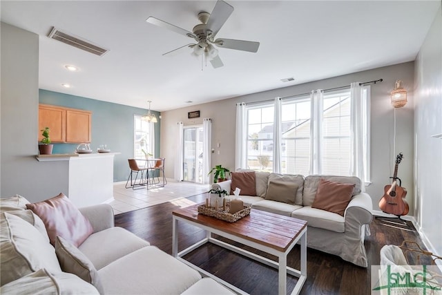 living room with ceiling fan and dark hardwood / wood-style floors