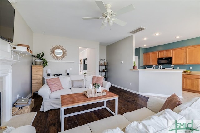 living room with ceiling fan and light hardwood / wood-style floors