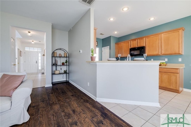 kitchen featuring light hardwood / wood-style floors and kitchen peninsula