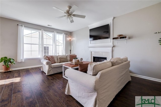 living room with ceiling fan and dark hardwood / wood-style floors