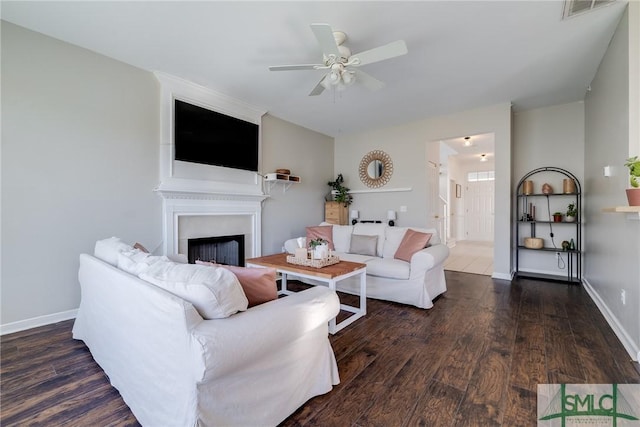 living room with ceiling fan and dark hardwood / wood-style flooring