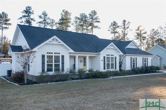 view of front of home featuring a front yard and central AC