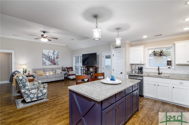 kitchen featuring hanging light fixtures, stainless steel dishwasher, dark hardwood / wood-style floors, tasteful backsplash, and white cabinetry