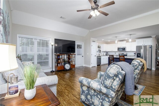 living room featuring ceiling fan, dark wood-type flooring, and ornamental molding