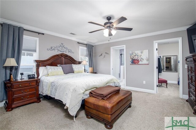 carpeted bedroom featuring ensuite bath, ceiling fan, and ornamental molding