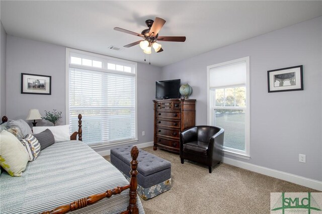 bedroom featuring ceiling fan and light carpet