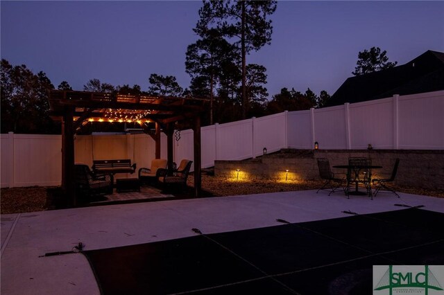 patio terrace at dusk with a pergola and outdoor lounge area