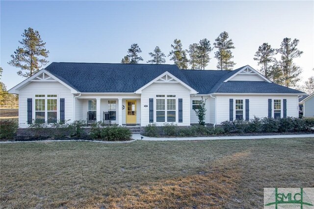 view of front of home with a front lawn and a porch