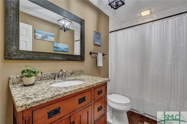 bathroom featuring hardwood / wood-style floors, vanity, crown molding, toilet, and a textured ceiling