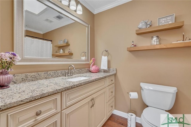 bathroom featuring toilet, vanity, wood-type flooring, and ornamental molding