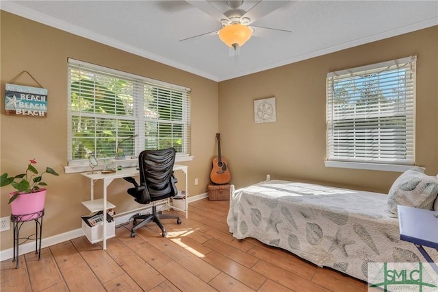 bedroom with light hardwood / wood-style flooring, ceiling fan, and ornamental molding