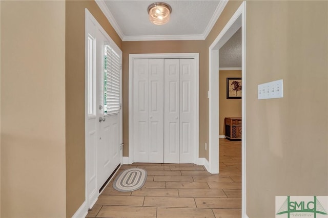 foyer featuring a textured ceiling, light hardwood / wood-style flooring, and crown molding