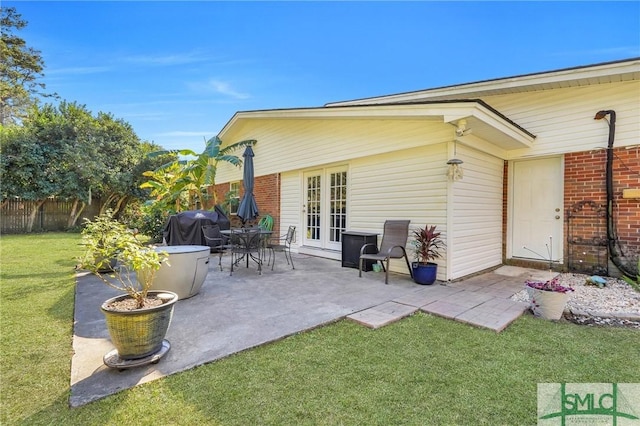 exterior space with a yard, a patio area, and french doors