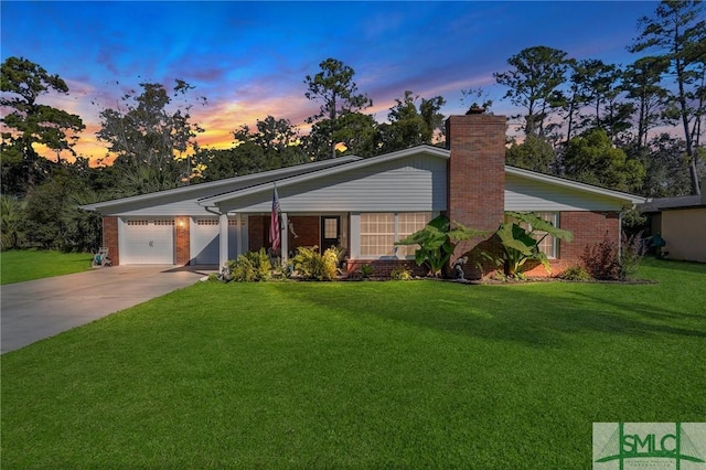 ranch-style home with a lawn and a garage