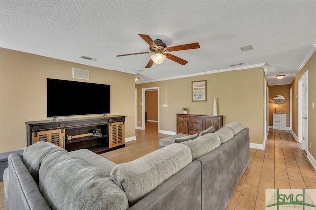 living room with ceiling fan, light hardwood / wood-style floors, crown molding, and a textured ceiling