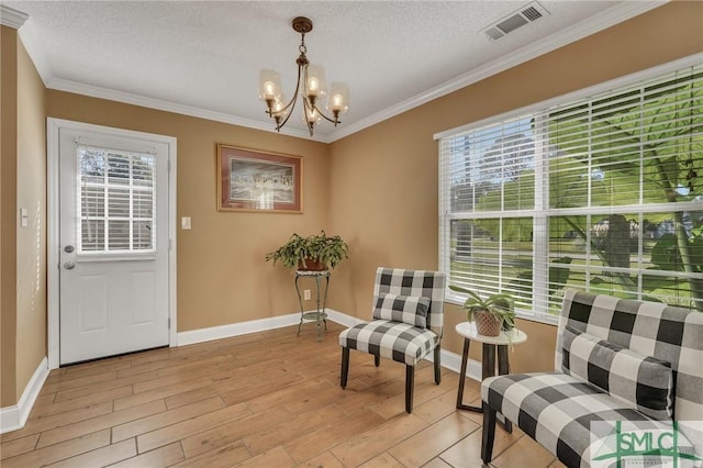 sitting room featuring a textured ceiling, light hardwood / wood-style floors, and plenty of natural light