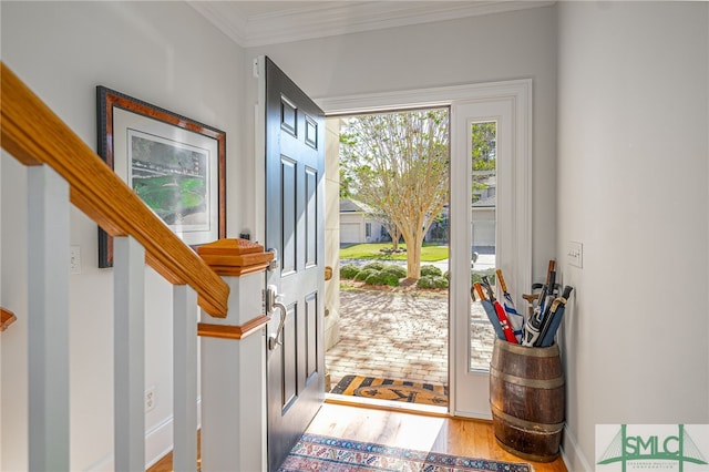 entrance foyer featuring light wood-type flooring and crown molding