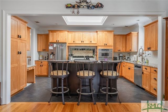 kitchen featuring a center island, dark wood-type flooring, sink, appliances with stainless steel finishes, and light stone counters