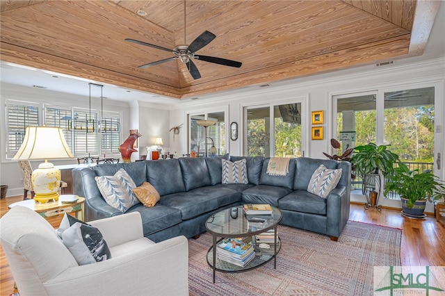 living room featuring light hardwood / wood-style floors, ceiling fan, wooden ceiling, and a tray ceiling