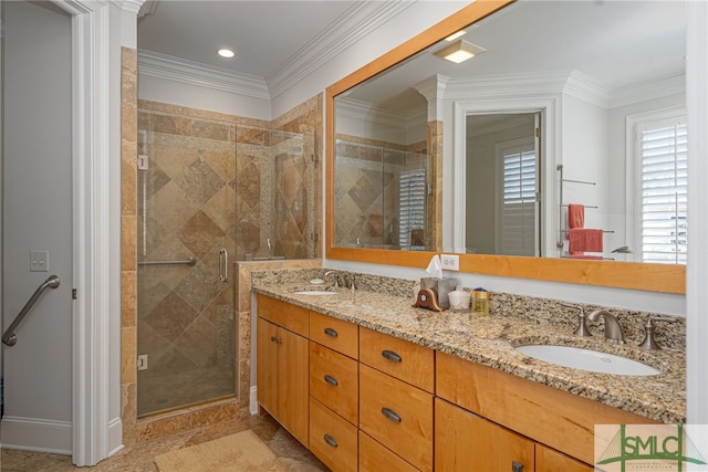 bathroom with vanity, a shower with shower door, and ornamental molding