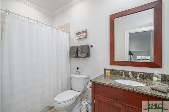 bathroom with toilet, vanity, and ornamental molding