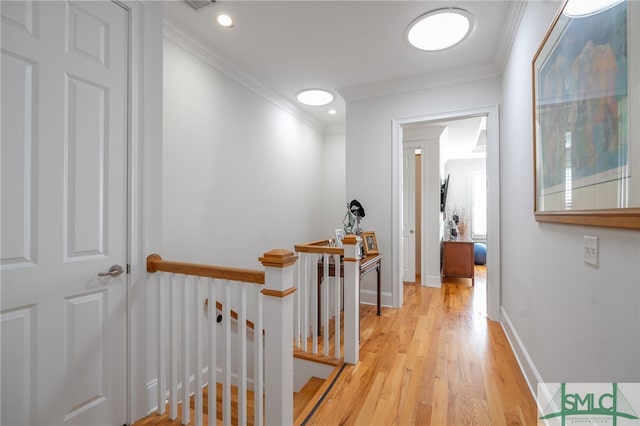 hall featuring light hardwood / wood-style flooring and ornamental molding