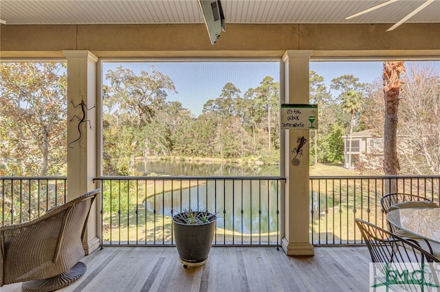 unfurnished sunroom with a water view and a wealth of natural light