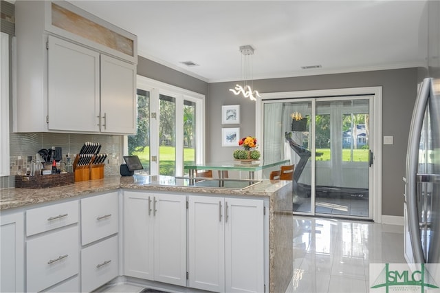 kitchen with black electric cooktop, light stone countertops, white cabinets, and a healthy amount of sunlight