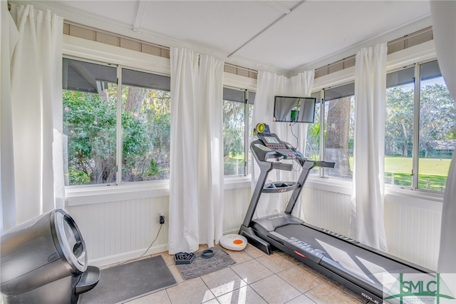 exercise area with plenty of natural light and light tile patterned floors