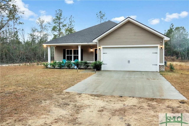 view of front of home featuring covered porch and a garage