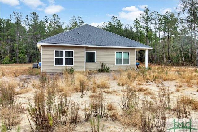 rear view of property featuring central AC unit