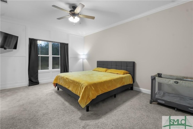 bedroom with carpet flooring, ceiling fan, and ornamental molding