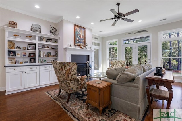 living room featuring dark hardwood / wood-style flooring, a wealth of natural light, ornamental molding, and ceiling fan