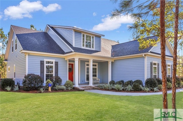 view of front of house with a front yard and a porch