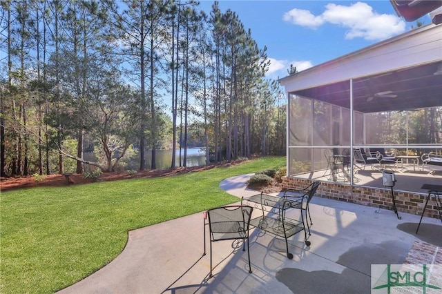 view of patio with a sunroom and a water view