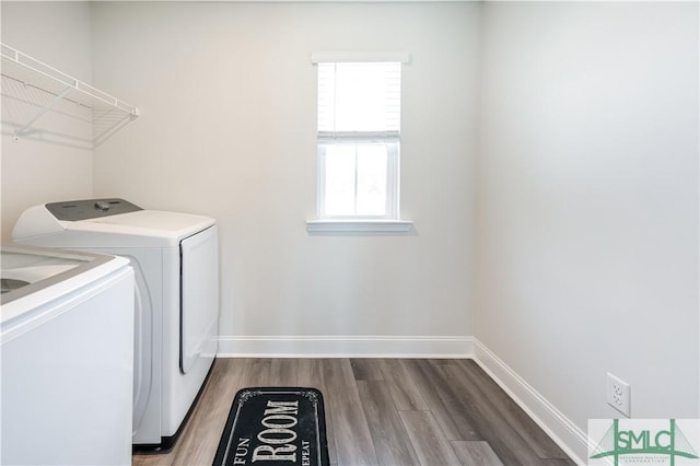 laundry area featuring independent washer and dryer and hardwood / wood-style floors