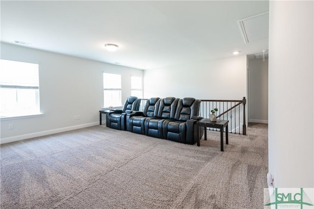 cinema with carpet floors and a wealth of natural light