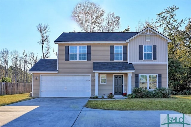 view of front of property with a front yard and a garage