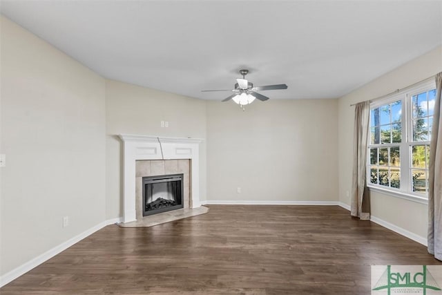 unfurnished living room featuring ceiling fan, a fireplace, and dark hardwood / wood-style floors